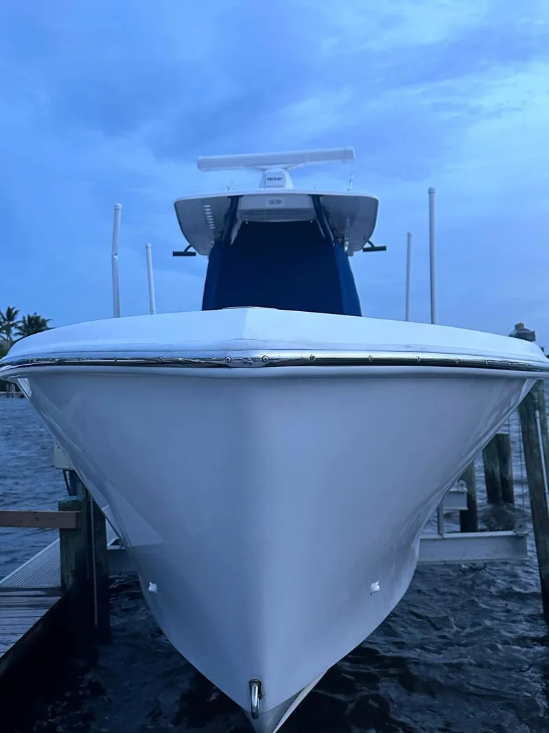 Slide: The Image of 2013 SeaHunter 35 Tournament boat docked, front view, under a cloudy sky. - 25