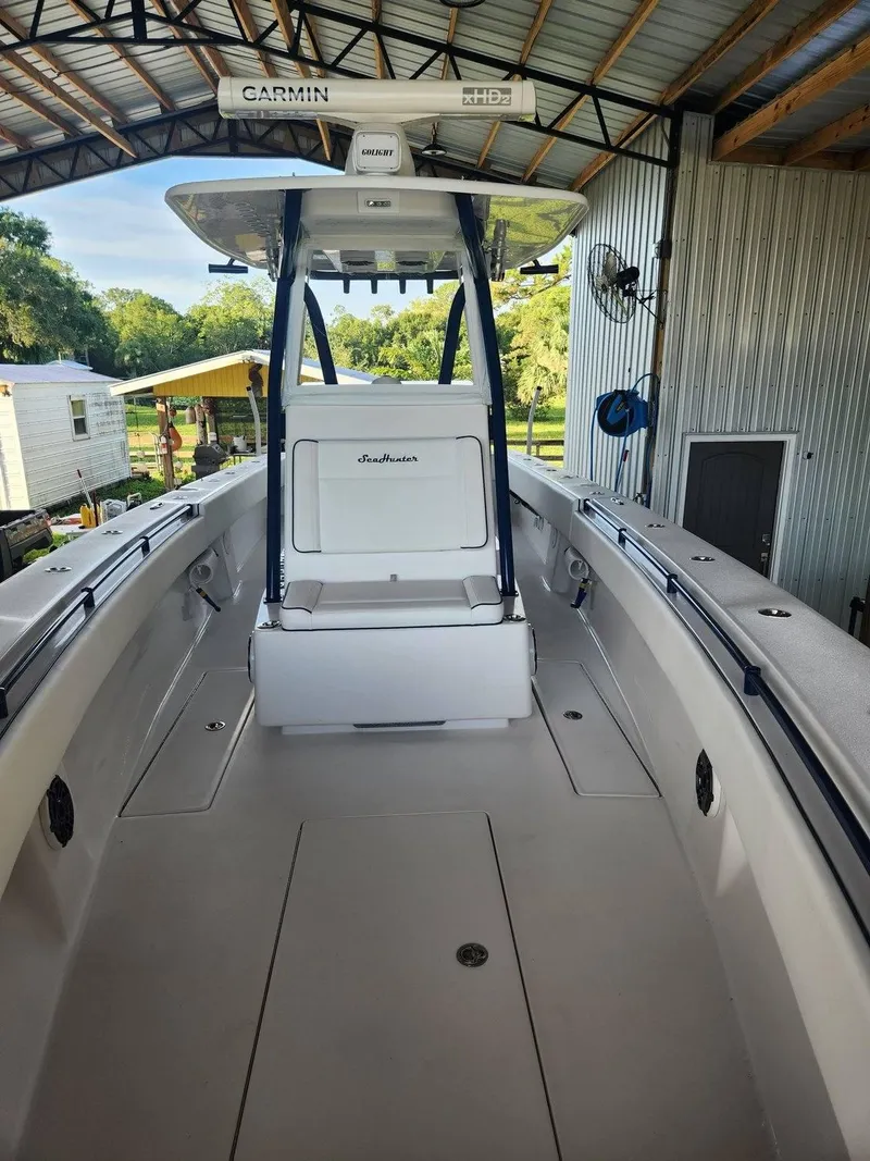 Slide: The Image of 2013 SeaHunter 35 Tournament boat with Garmin equipment, docked in a covered area. - 27