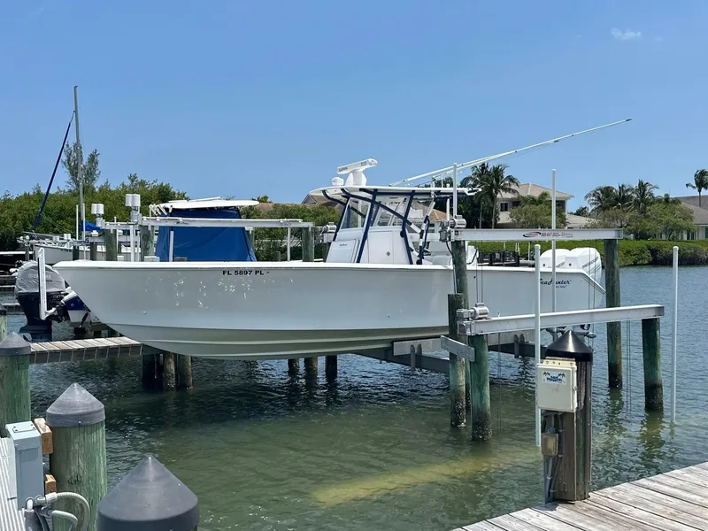 Slide: The Image of 2013 SeaHunter 35 Tournament boat docked on a lift in a marina. - 28