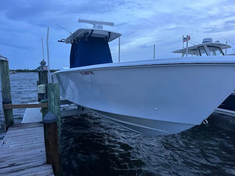 Slide: The Image of 2013 SeaHunter 35 Tournament boat docked by the water under a cloudy sky. - 31