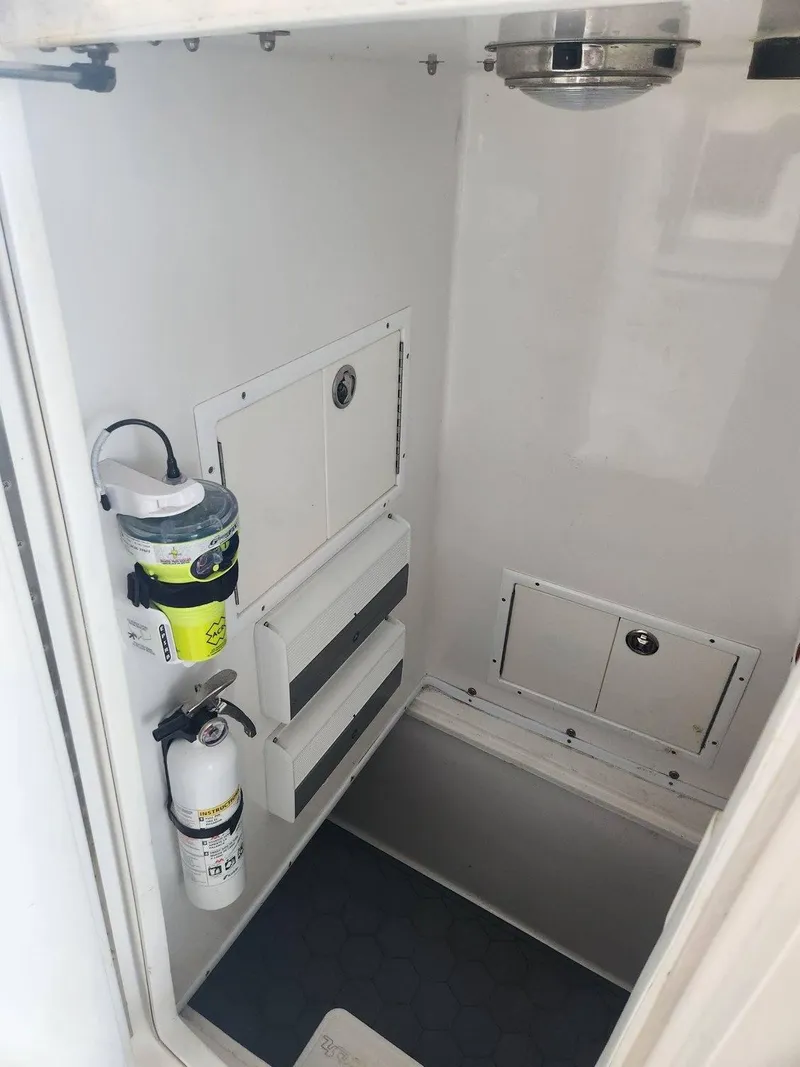 Slide: The Image of 2013 SeaHunter 35 Tournament interior storage with safety equipment and organized compartments. - 32