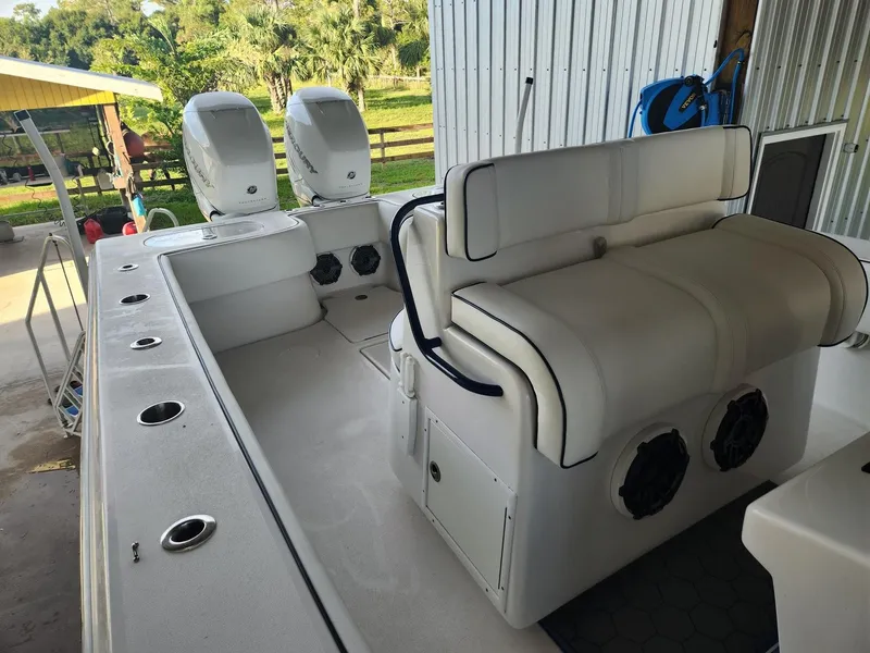 Slide: The Image of 2013 SeaHunter 35 Tournament boat with dual engines and white seating in a docked setting. - 34
