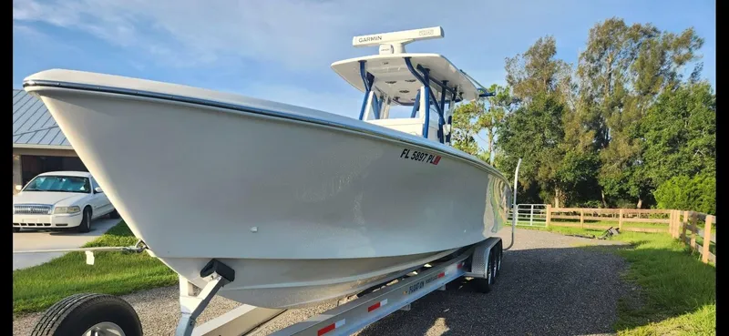 Slide: The Image of 2013 SeaHunter 35 Tournament boat on trailer, parked outdoors on a sunny day. - 4