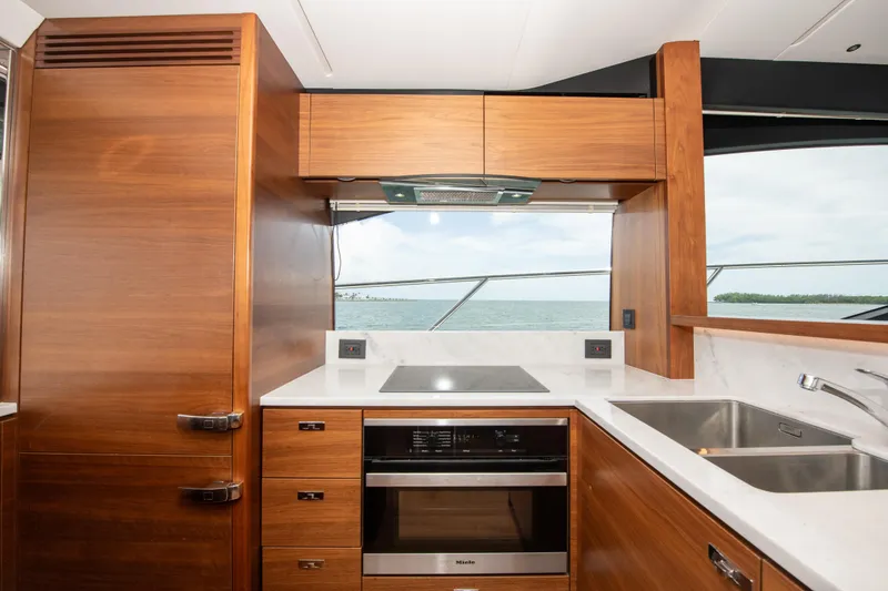 Slide: The Image of Modern kitchen interior on 2021 Princess S66 yacht with wood cabinetry and ocean view. - 20