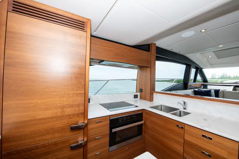Slide: The Image of Luxurious kitchen interior of 2021 Princess S66 yacht with wooden cabinetry and modern appliances. - 21