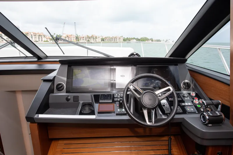 Slide: The Image of Cockpit of 2021 Princess S66 yacht with modern navigation controls and steering wheel. - 23
