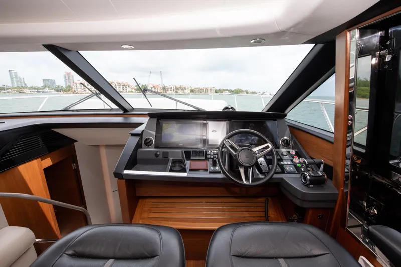 Slide: The Image of Luxurious 2021 Princess S66 yacht helm with modern navigation controls and panoramic windows. - 24
