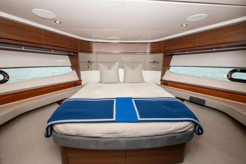Slide: The Image of Luxurious bedroom interior of 2021 Princess S66 yacht with elegant wood finishes and blue blanket. - 30