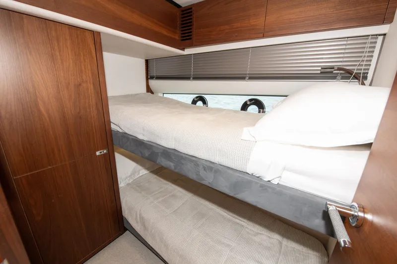 Slide: The Image of Luxurious 2021 Princess S66 yacht cabin with wooden interior and cozy bunk beds. - 35