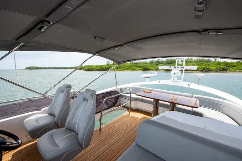 Slide: The Image of Luxurious 2021 Princess S66 yacht interior with seating and table, overlooking serene waters. - 37