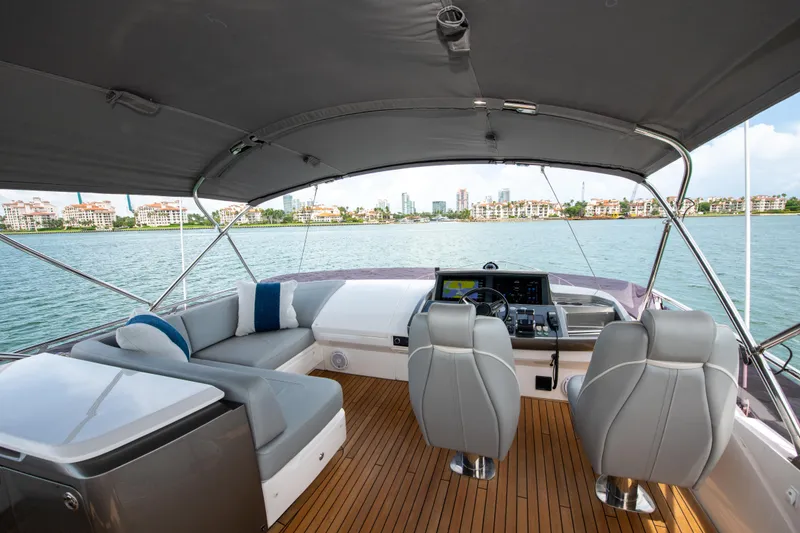 Slide: The Image of Luxurious 2021 Princess S66 yacht interior with sleek seating and modern controls, overlooking scenic waterfront. - 40