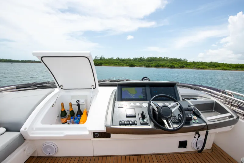 Slide: The Image of 2021 Princess S66 yacht helm with open cooler, bottles, and scenic water view. - 41