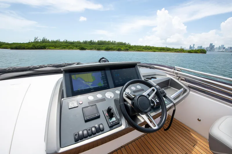 Slide: The Image of Helm of 2021 Princess S66 yacht with navigation screens, steering wheel, and ocean view. - 42