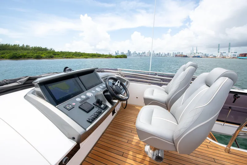 Slide: The Image of 2021 Princess S66 yacht helm with dual seats, overlooking scenic waterfront and city skyline. - 43