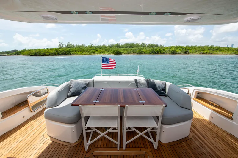 Slide: The Image of Luxury yacht Princess S66 deck with seating, table, and American flag, 2021 model. - 49