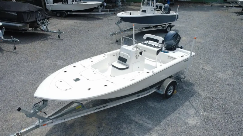 Slide: The Image of 2025 Tidewater 1910 Bay Max boat on trailer in a gravel lot. - 0