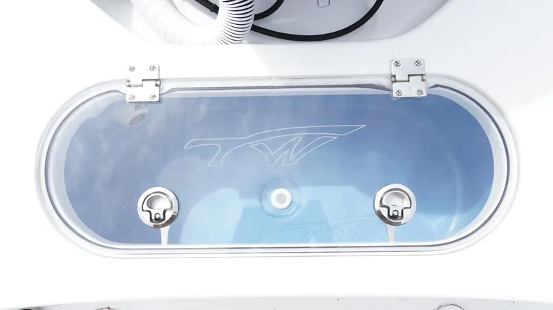 Slide: The Image of Livewell on 2025 Tidewater 1910 Bay Max boat, featuring transparent lid and secure latches. - 15