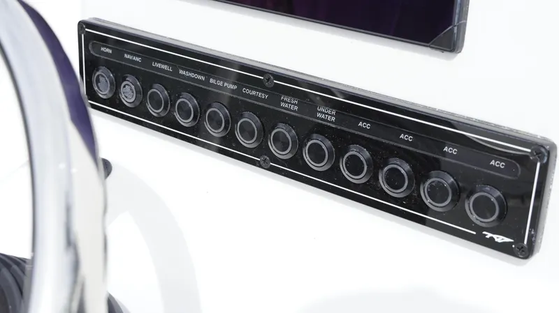 Slide: The Image of Control panel of 2025 Tidewater 1910 Bay Max boat with labeled switches. - 23