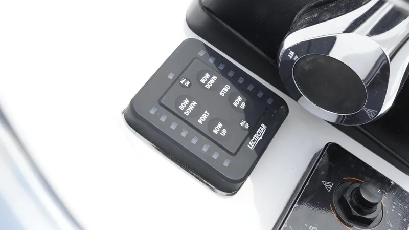 Slide: The Image of Control panel of 2025 Tidewater 1910 Bay Max boat with trim tab switches. - 24