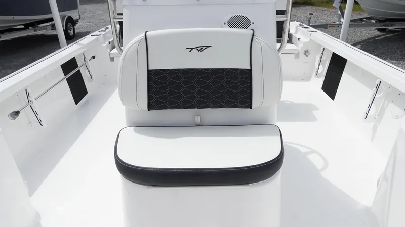 Slide: The Image of 2025 Tidewater 1910 Bay Max boat interior with cushioned seating and sleek design. - 26