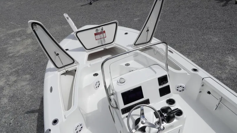 Slide: The Image of 2025 Tidewater 1910 Bay Max boat interior with open storage compartments and steering console. - 5