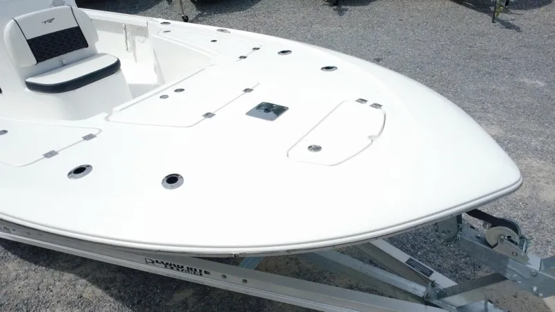 Slide: The Image of 2025 Tidewater 1910 Bay Max boat on trailer, white deck, sleek design. - 7