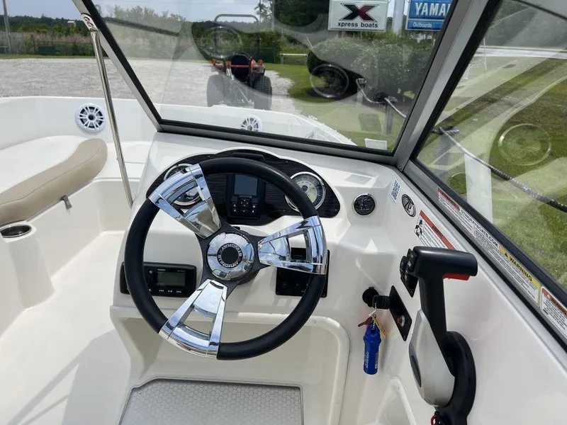 Slide: The Image of 2019 Stingray 191DC (OB) boat dashboard with steering wheel and controls. - 11