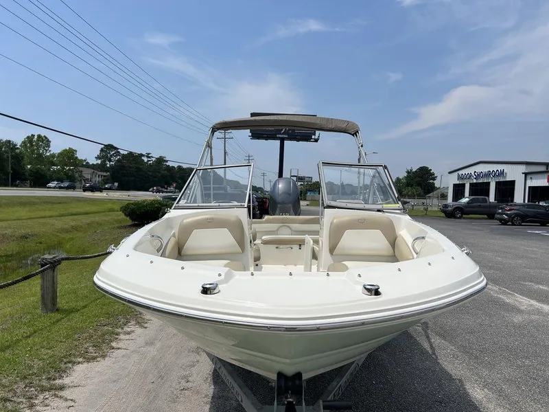 Slide: The Image of 2019 Stingray 191DC (OB) boat parked outdoors, front view, clear sky background. - 5
