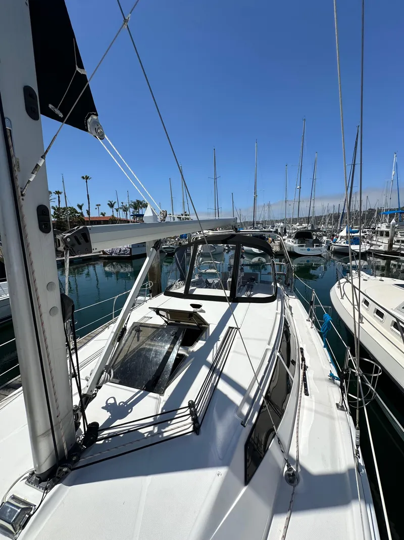 Slide: The Image of 2013 Hunter 33 sailboat docked in a marina under clear blue skies. - 17