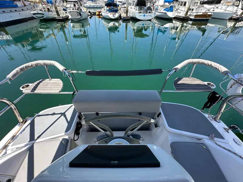 Slide: The Image of Hunter 33 sailboat cockpit, 2013 model, docked in marina with calm water reflections. - 22
