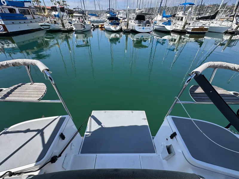 Slide: The Image of Hunter 33 sailboat stern view in marina, 2013 model, surrounded by docked boats. - 23