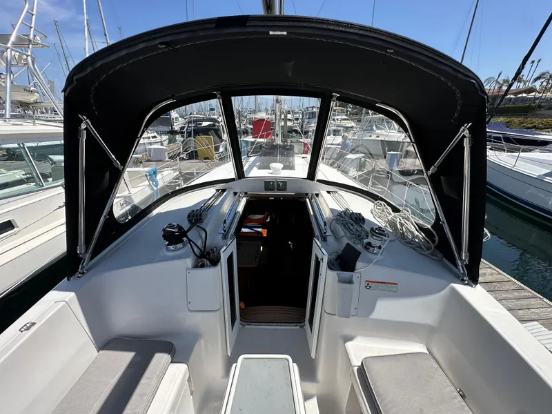 Slide: The Image of 2013 Hunter 33 sailboat cockpit with black canopy, docked in marina. - 30