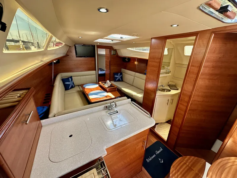 Slide: The Image of Luxurious interior of 2013 Hunter 33 sailboat with modern amenities and elegant wood finish. - 38