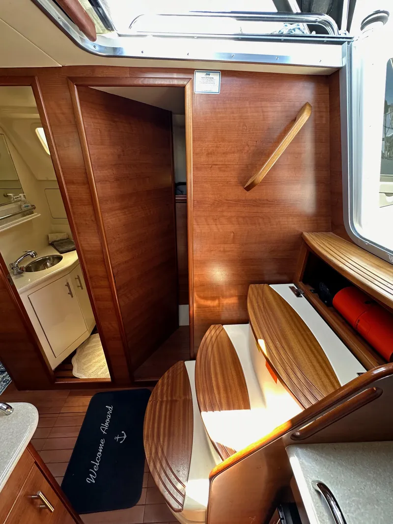 Slide: The Image of Interior of 2013 Hunter 33 sailboat with wooden finishes and compact bathroom. - 39