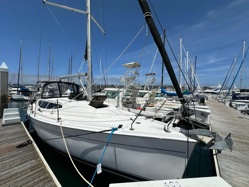 Slide: The Image of 2013 Hunter 33 sailboat docked at marina under clear blue sky. - 4