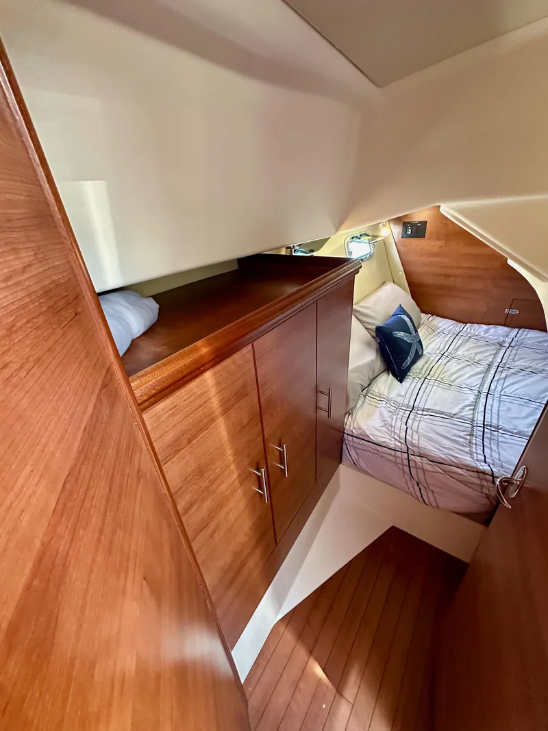Slide: The Image of 2013 Hunter 33 yacht interior with wooden cabinetry and cozy bed. - 40