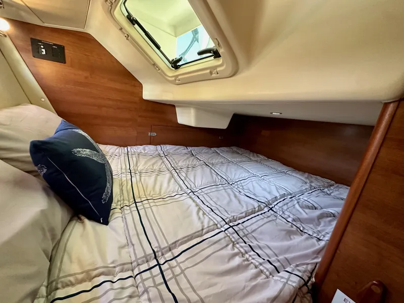 Slide: The Image of Cozy cabin interior of 2013 Hunter 33 sailboat with bed and window. - 42