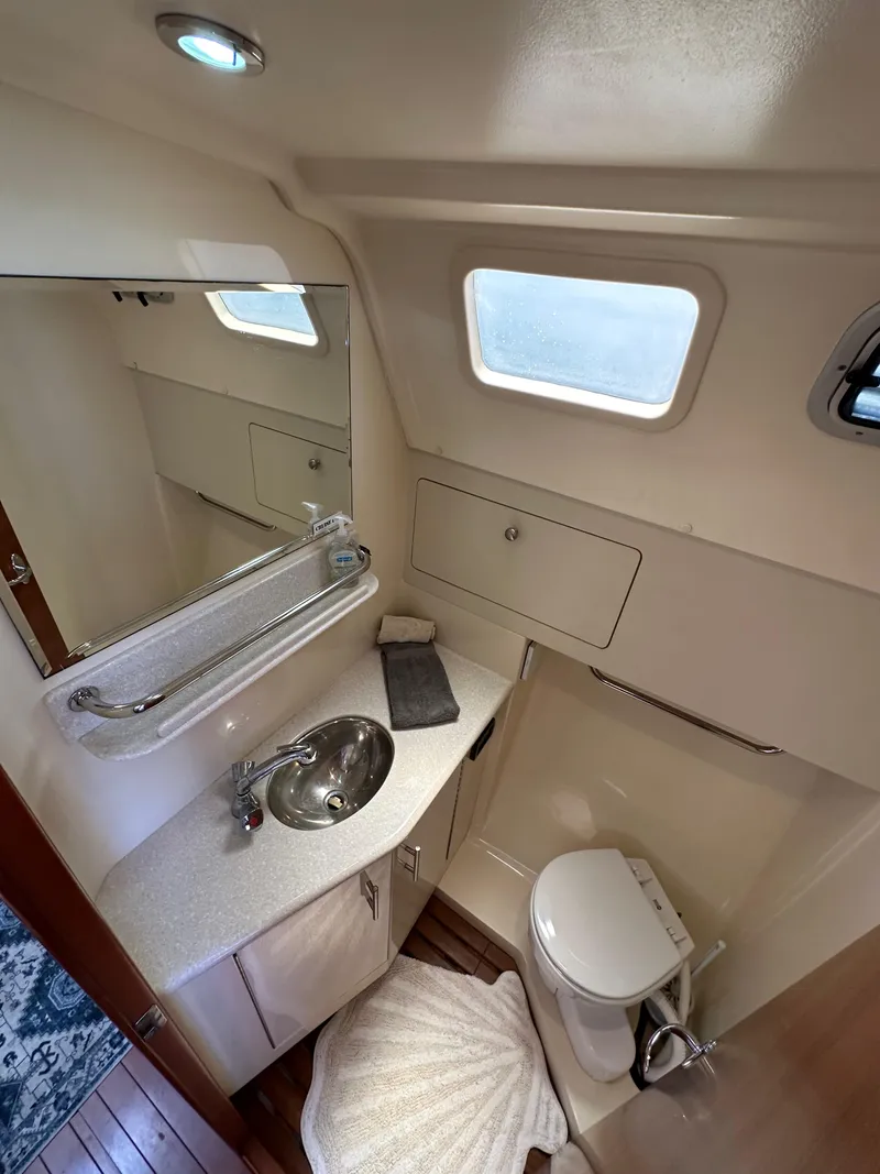 Slide: The Image of 2013 Hunter 33 yacht bathroom with sink, mirror, and toilet. - 45