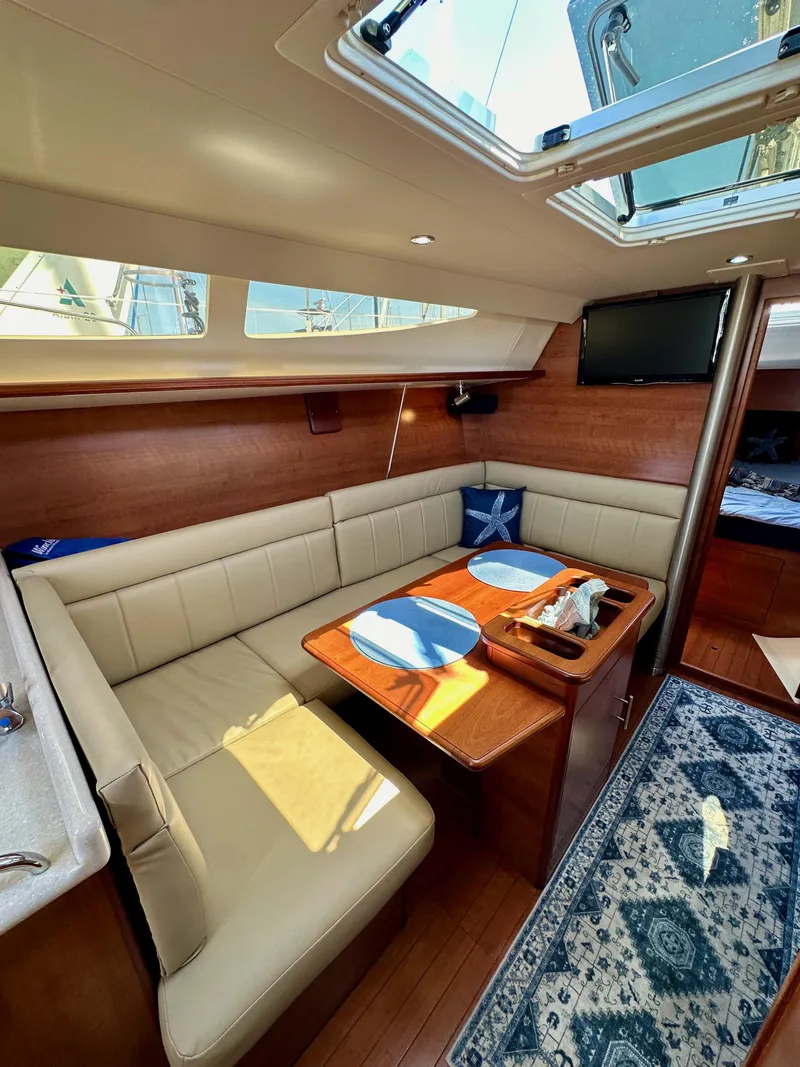 Slide: The Image of Interior of a 2013 Hunter 33 sailboat with cozy seating and dining area. - 47