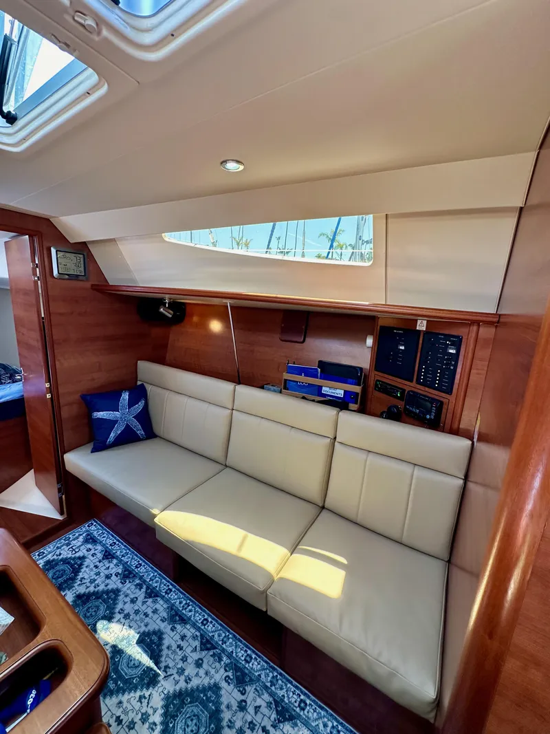Slide: The Image of Interior of 2013 Hunter 33 yacht with beige seating and nautical decor. - 48