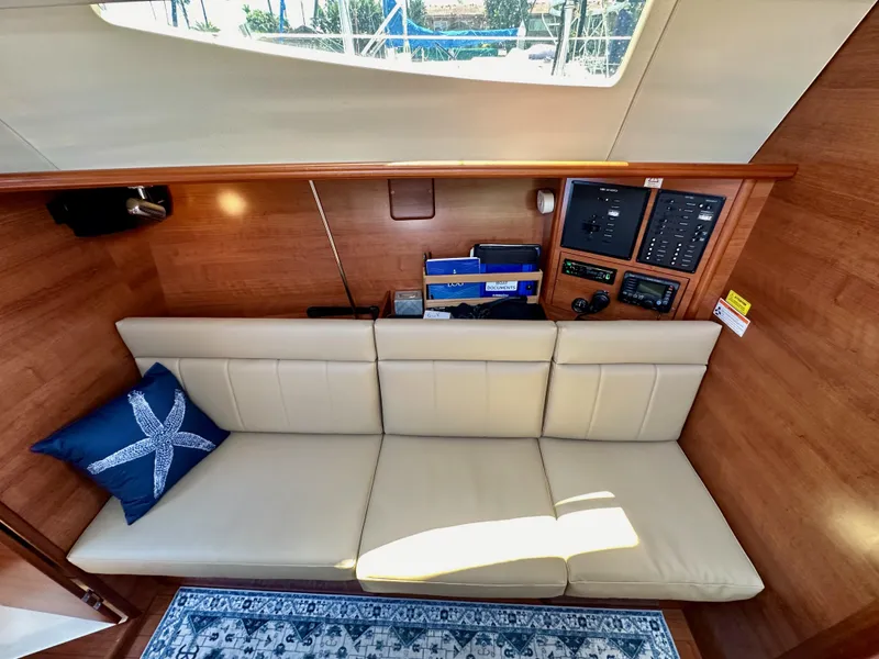 Slide: The Image of Interior of 2013 Hunter 33 yacht with beige sofa and nautical-themed decor. - 49