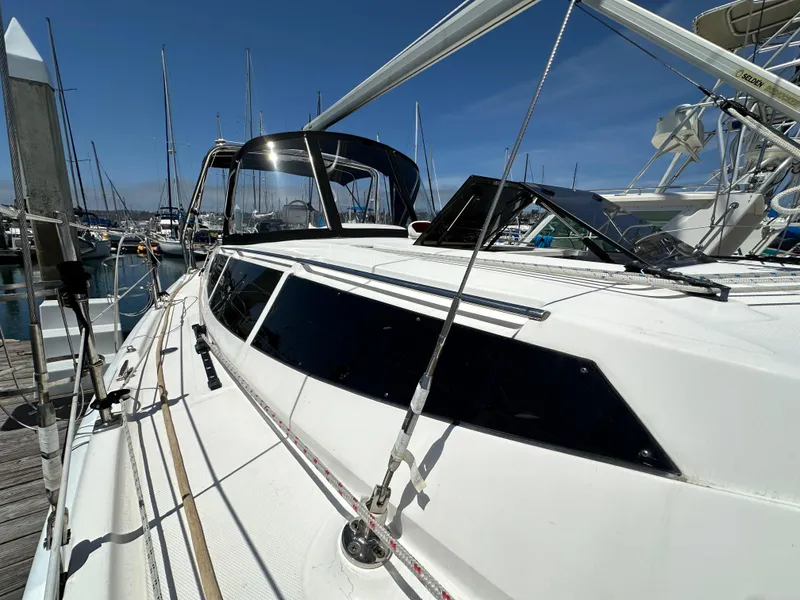 Slide: The Image of 2013 Hunter 33 sailboat docked at marina under clear blue sky. - 5