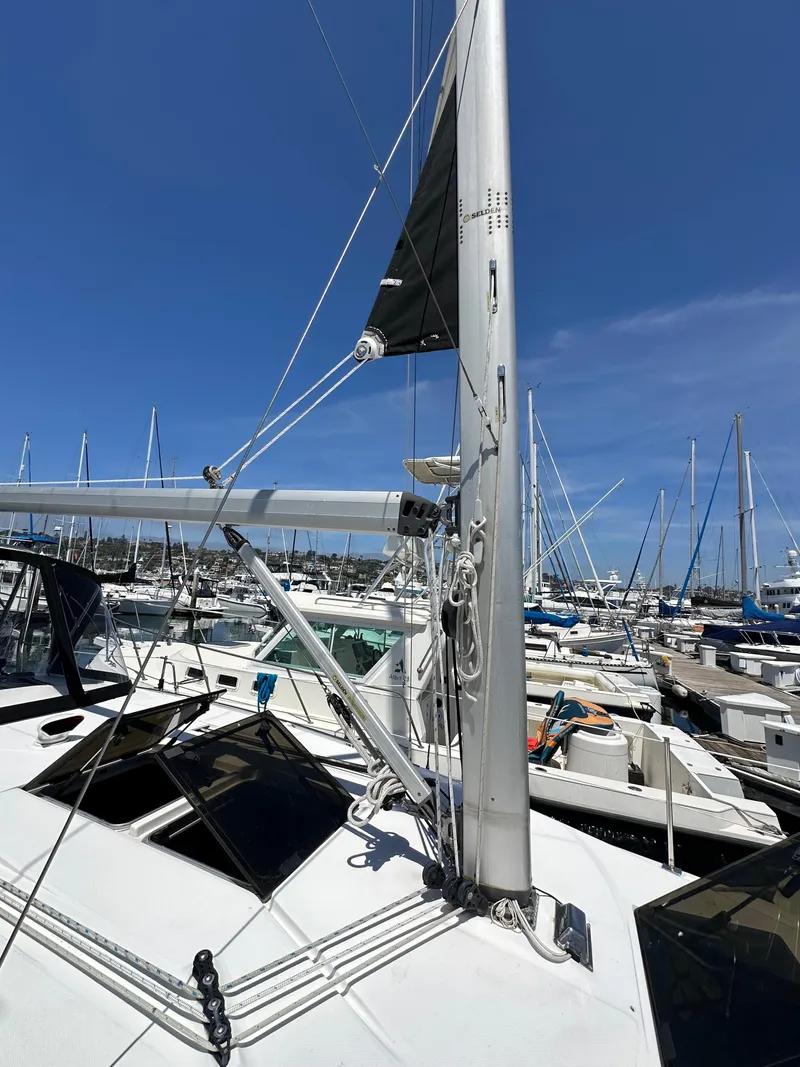Slide: The Image of 2013 Hunter 33 sailboat docked in marina, clear blue sky, multiple boats in background. - 6