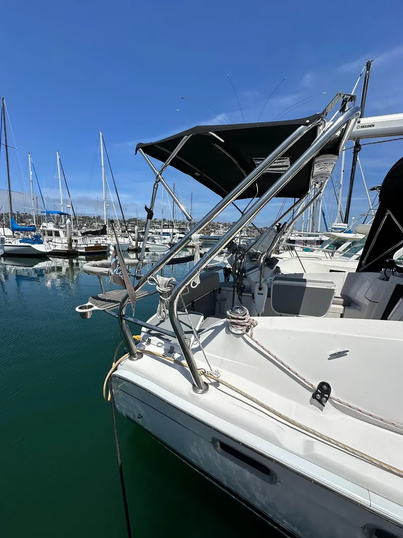 Slide: The Image of 2013 Hunter 33 sailboat docked in marina with blue sky background. - 8