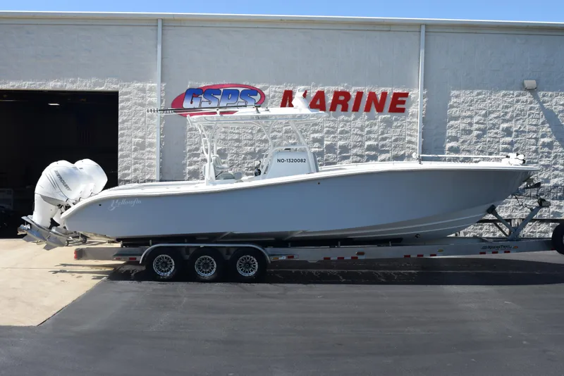 Slide: The Image of 2022 Yellowfin 34 Offshore boat on trailer outside marine dealership. - 1