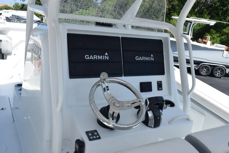 Slide: The Image of 2022 Yellowfin 34 Offshore boat console with dual Garmin displays and steering wheel. - 10