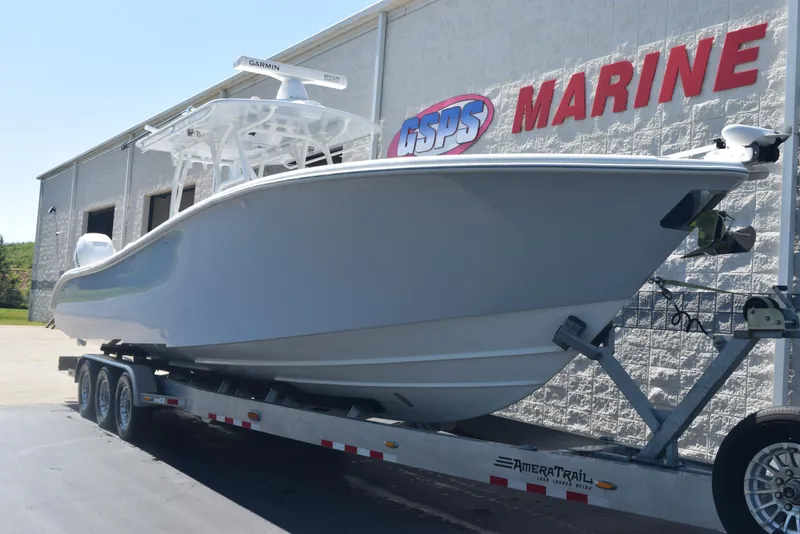 Slide: The Image of 2022 Yellowfin 34 Offshore boat on trailer outside marine dealership. - 2