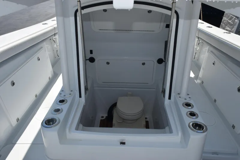 Slide: The Image of 2022 Yellowfin 34 Offshore boat interior with a compact marine toilet. - 24