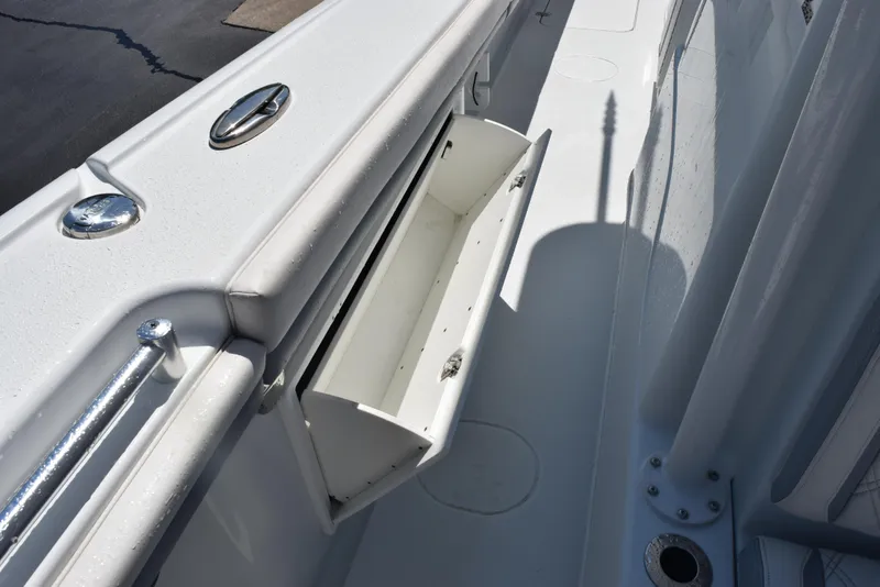 Slide: The Image of 2022 Yellowfin 34 Offshore boat storage compartment, open and empty, with sleek white finish. - 26
