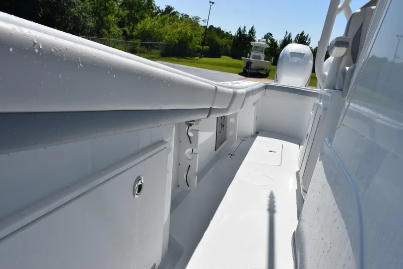 Slide: The Image of 2022 Yellowfin 34 Offshore boat deck with storage compartments and sleek design. - 27